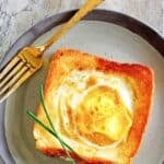 Homemade Cracker Barrel egg in a basket and a fork on a plate.