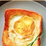 Copycat Cracker Barrel egg in a basket garnished with chives.