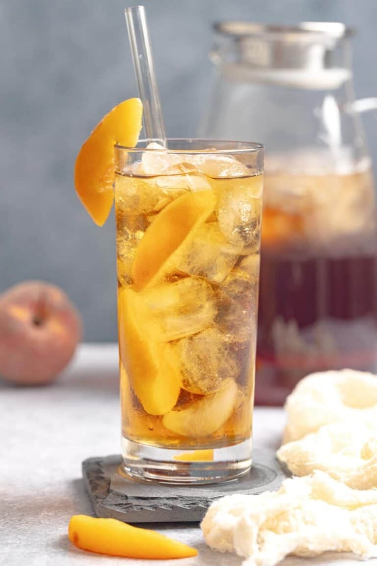 Iced tea made with fresh peach syrup and served with peach slices.