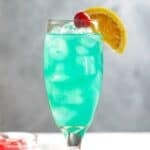 Copycat Olive Garden Blue Capri cocktail garnished and on a coaster.
