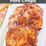 Air fryer thick cut seasoned pork chops on a platter.