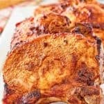 Air fryer thick cut pork chops on a long platter.