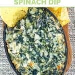Copycat Cheddar's Santa Fe spinach dip served in a small cast-iron dish.