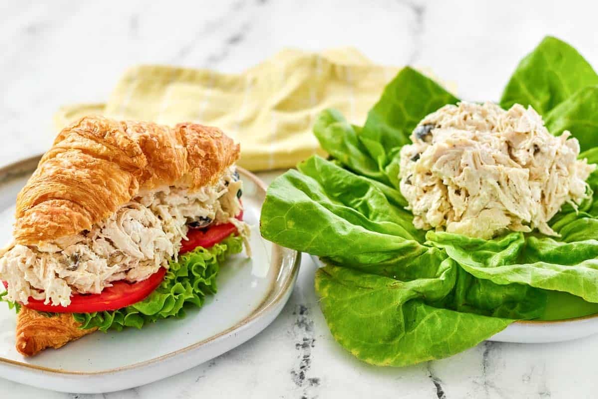 Creamy shredded chicken, olive, and feta salad served on lettuce and in a sandwich.