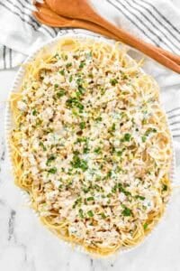 Creamy clam sauce served over pasta on a large platter.