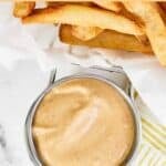 Copycat Freddy's fry sauce in a small cup next to fries.