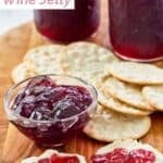 Homemade wine jelly in jars and served with cheese and crackers.