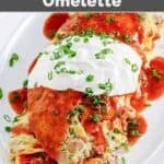 Copycat IHOP Colorado Omelette topped with picante sauce, sour cream, and chives.