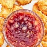 A small bowl of copycat Joe's Crab Shack dipping sauce and fried shrimp around it.