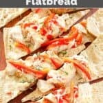 Slices of copycat Olive Garden grilled chicken flatbread on a wood serving board.