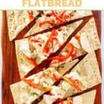 Copycat Olive Garden grilled chicken flatbread sliced on a wooden board.