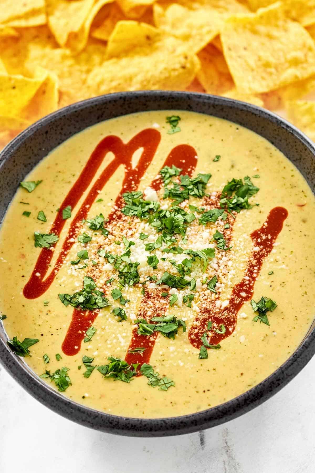Queso made with green chiles and tomatillos served with guacamole.