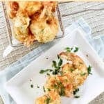 Crispy fried shrimp tempura on a plate and in a basket.