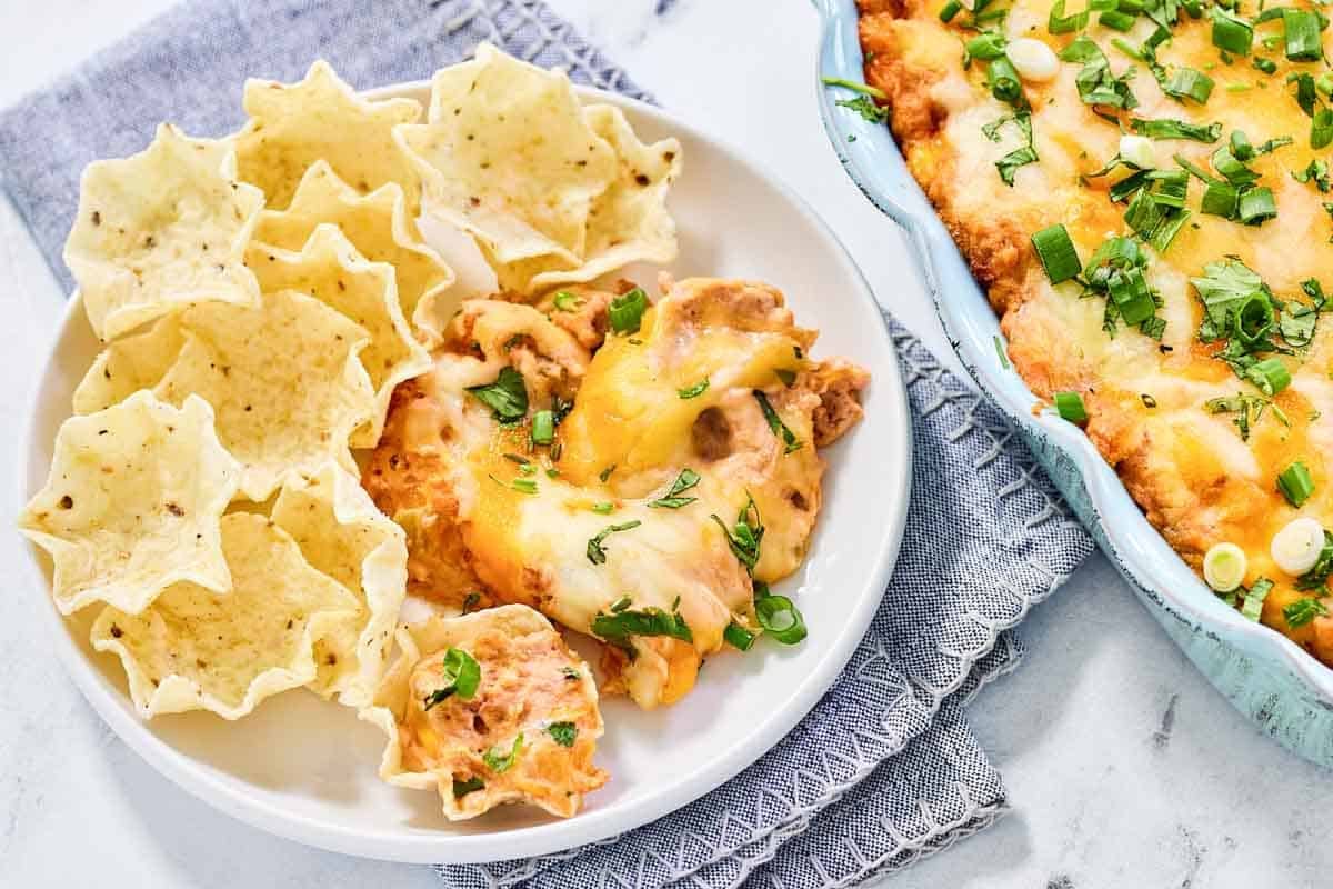 A plate of cheesy Tex-Mex bean dip and tortilla chops.