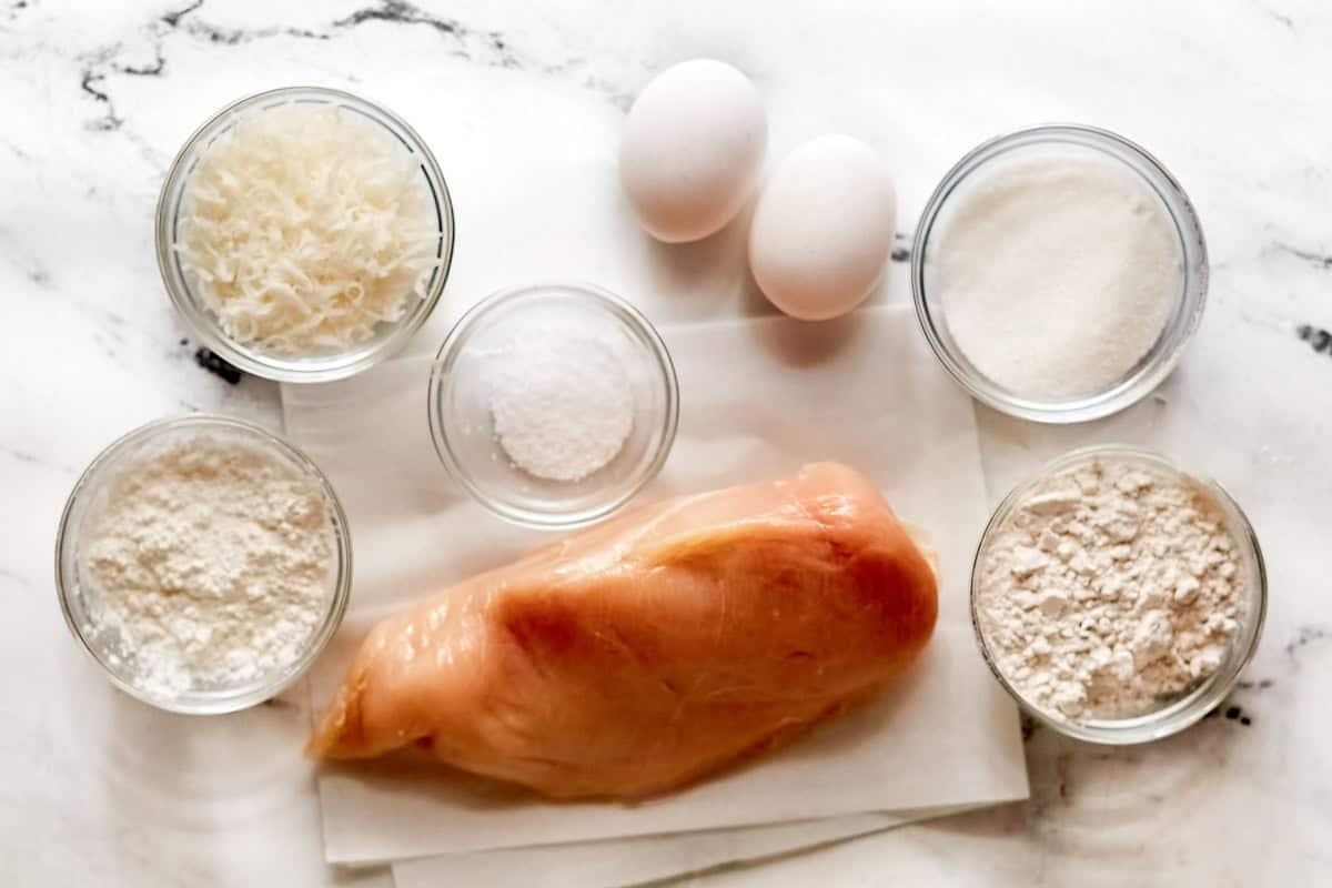Chicken, coconut flakes, eggs, flour, sugar, cornstarch, and salt.