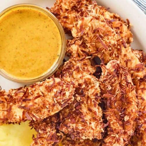 Coconut fried chicken breast strips, honey mustard sauce, and pineapple.