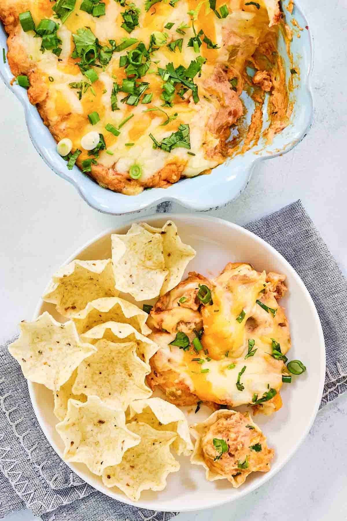 Cream cheese bean dip with melted Mexican cheese on top.