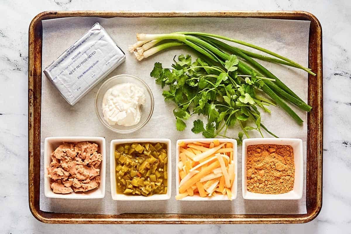 Cream cheese, refried beans, sour cream, Mexican cheese blend, herbs, and seasonings.