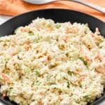 A bowl of creamy coleslaw made with cabbage and veggies.