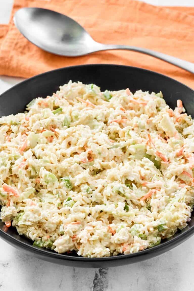 A bowl of creamy coleslaw made with cabbage and veggies.