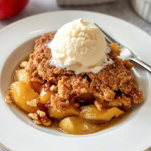 Apple walnut cobbler topped with vanilla ice cream.
