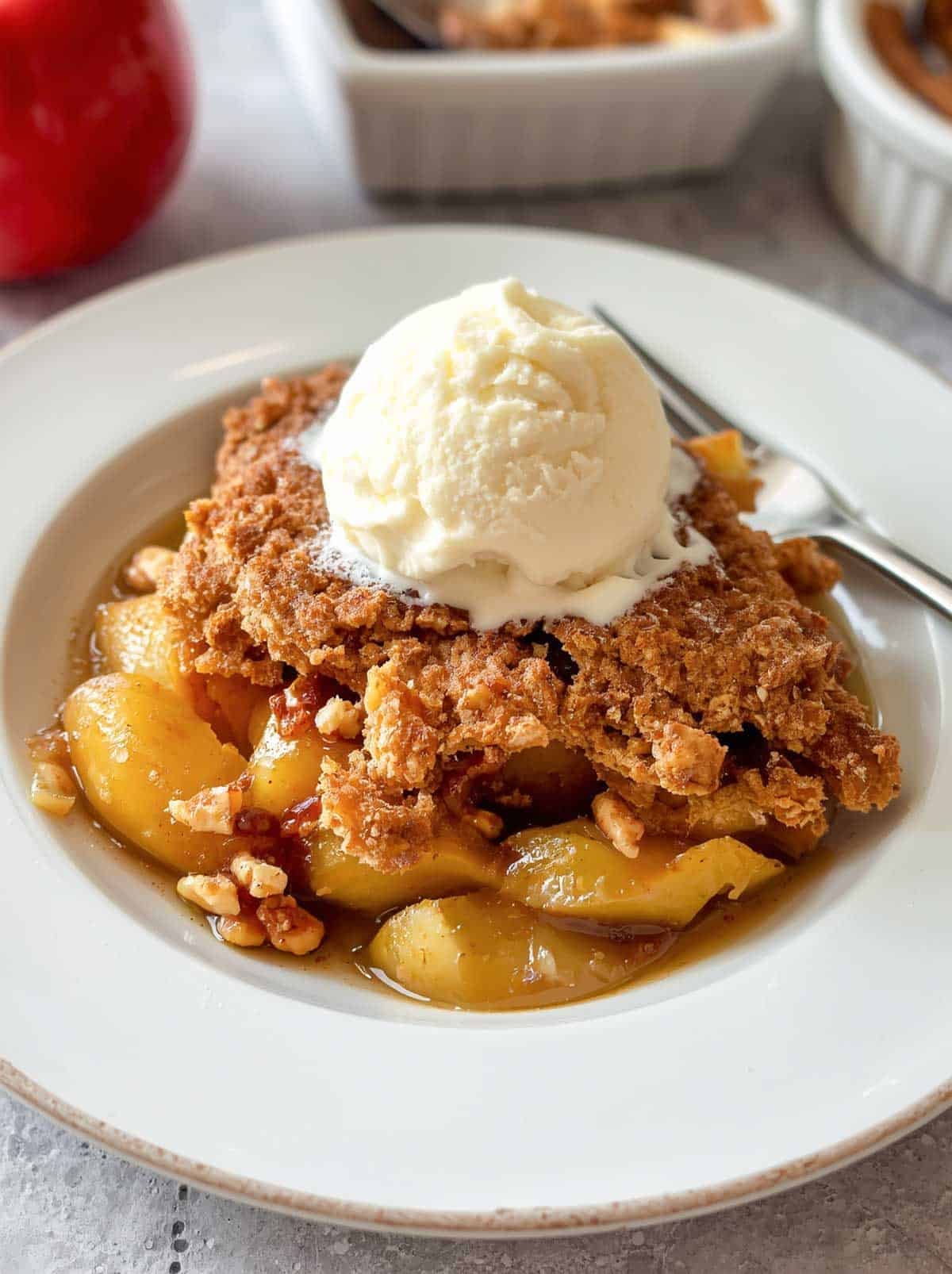 Apple walnut cobbler topped with vanilla ice cream.