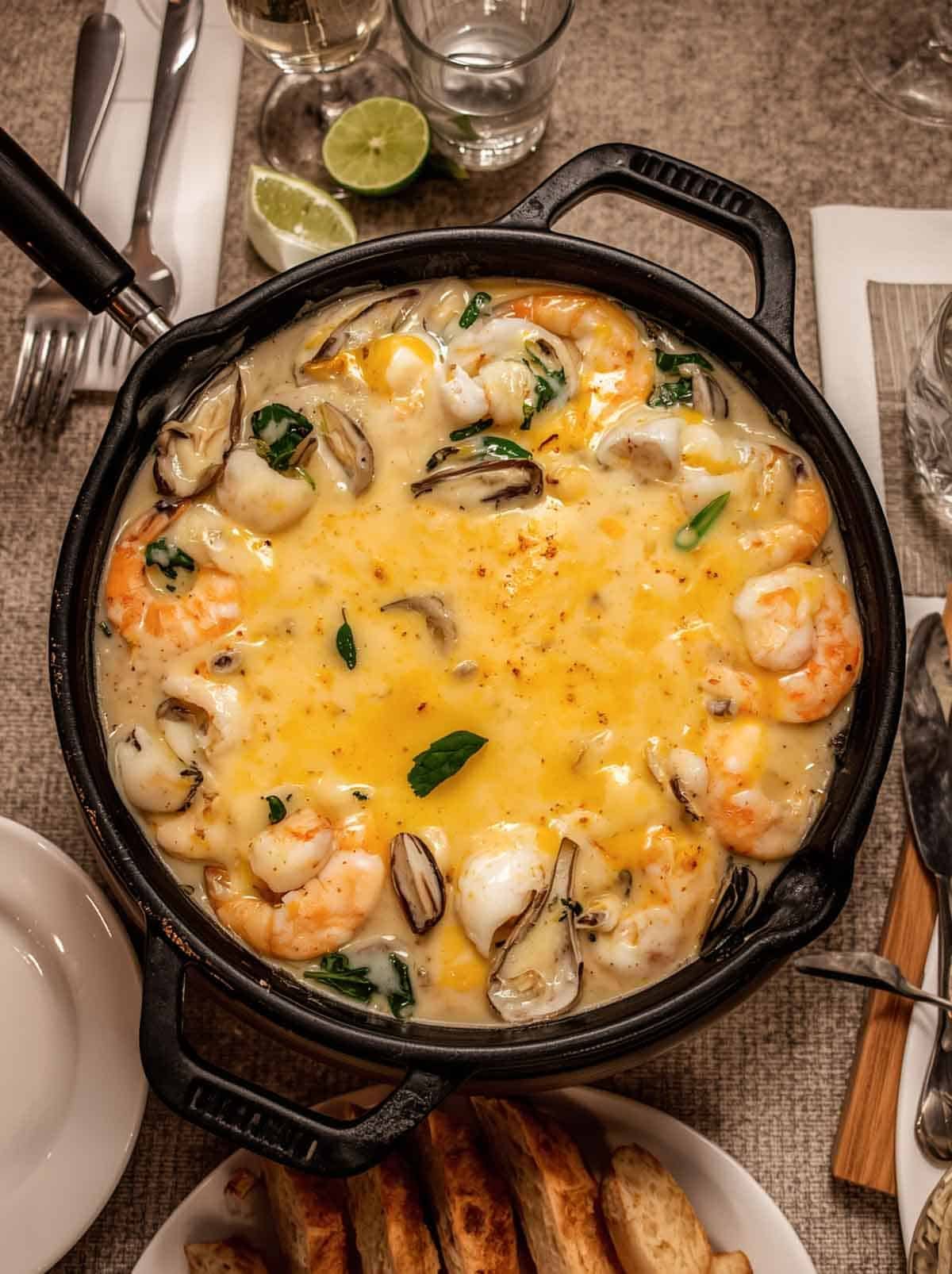 Cheesy fondue with oysters and shrimp.