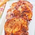 A platter of seasoned and cooked bone-in pork chops.