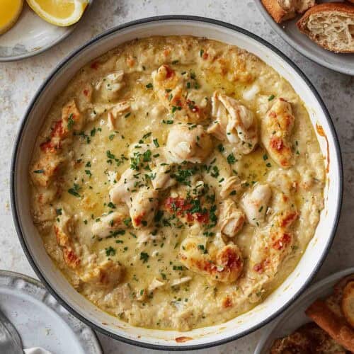 Hot crab dip, lemon slices, sliced bread.