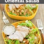 Copycat Applebee's grilled chicken Oriental salad in two bowls and forks next to them.