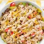 Homemade Big Mac salad with Big Mac sauce in a salad bowl.
