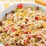 Big Mac salad with homemade Big Mac sauce in a large bowl.