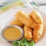 Copycat Chili's chicken crispers and honey mustard dipping sauce on a plate.