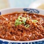 Copycat Chili's original chili in a bowl and garnished with chopped green onions.