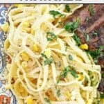 A plate with copycat Souper Salad fettuccine pasta salad and sliced steak.