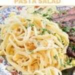 Copycat Souper Salad fettuccine pasta salad on a plate with steak.