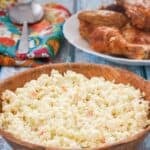 Copycat KFC coleslaw and a plate fried chicken behind it.