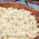 A bowl of copycat KFC coleslaw on a wood table.