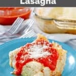 Copycat Olive Garden five cheese lasagna topped with marinara sauce and grated parmesan.