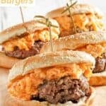 Homemade pimento cheese burgers on a wooden platter.