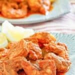 Copycat Red Lobster Cajun shrimp and lemon wedges on a plate.
