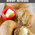 Copycat Saltgrass Steakhouse shiner bock beer bread served with butter on a wooden cutting board.