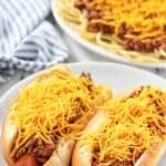 Hot dogs topped with copycat Skyline chili and shredded cheese.