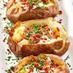 Copycat Texas Roadhouse baked potatoes on a platter.