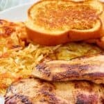 Copycat Waffle House grilled chicken breasts with hashbrowns and toast.