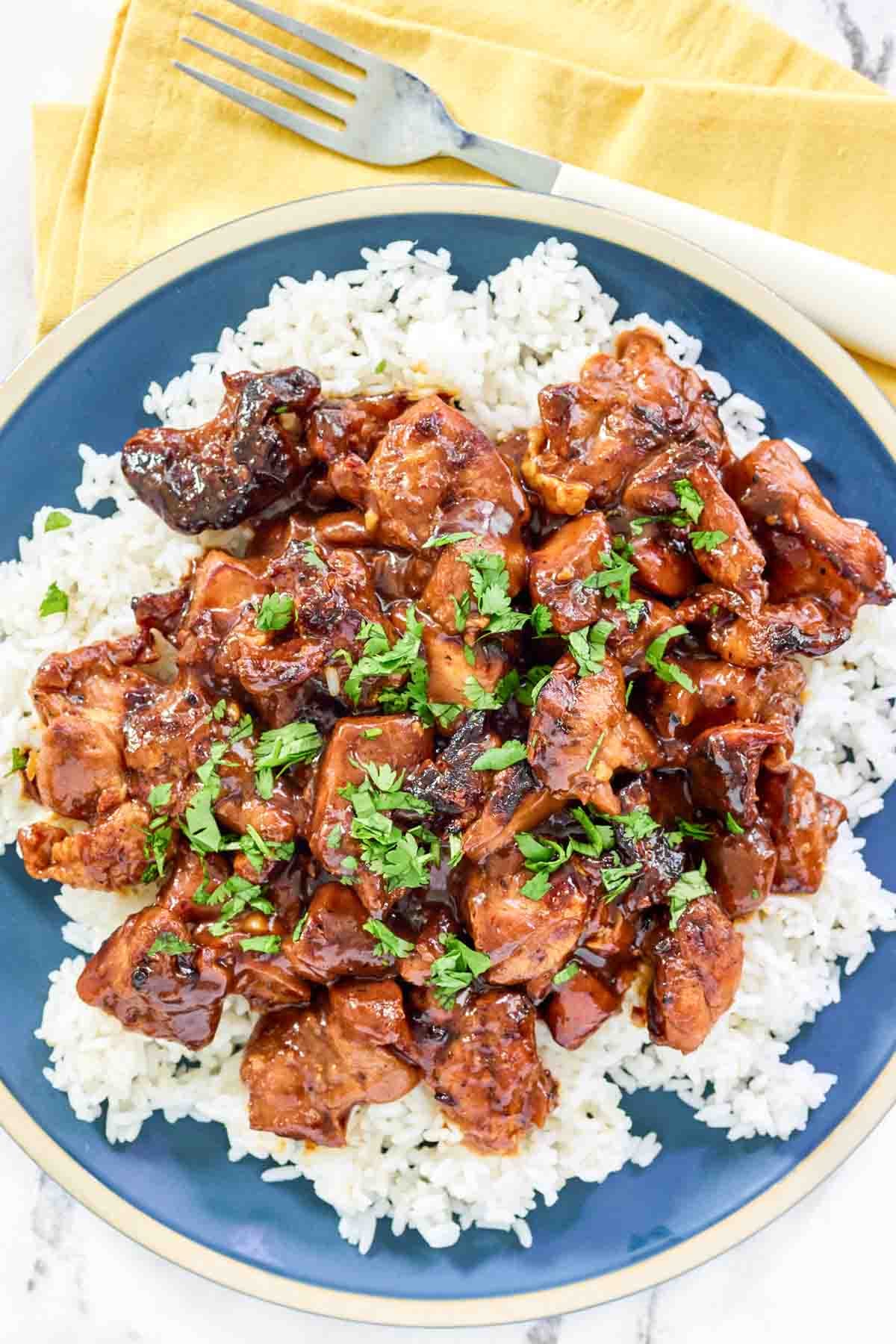 Brown sugar bourbon sauce chicken thigh pieces served over rice.