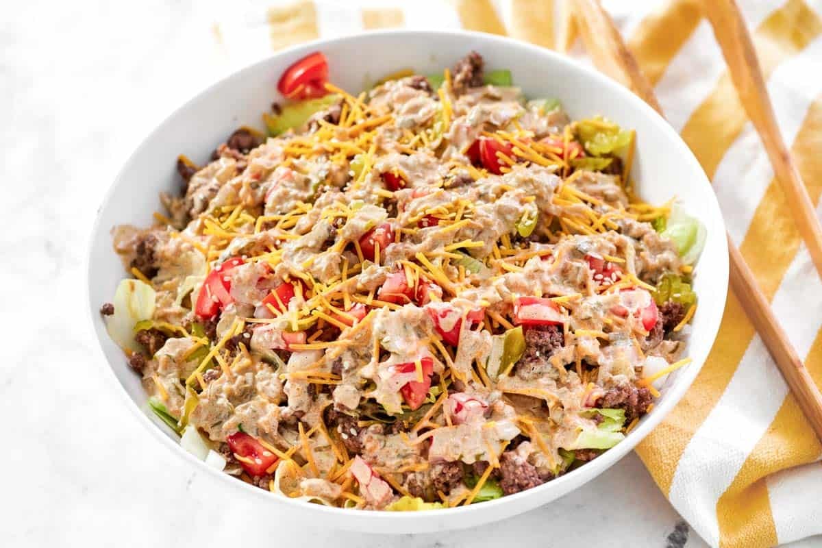 A burger chopped salad with creamy dressing.