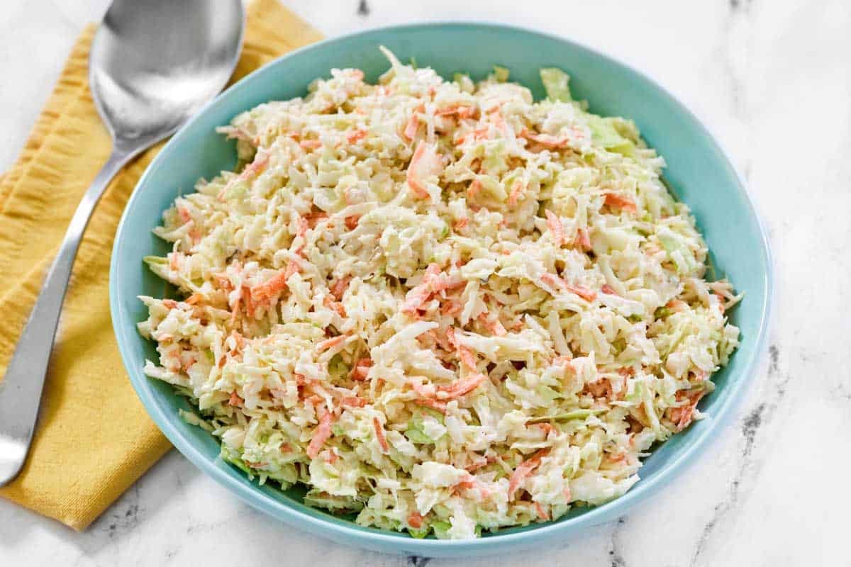 Creamy cabbage, carrot, onion, and pickle relish slaw.