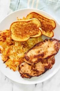 Grilled chicken, hashbrowns, and toast dinner.