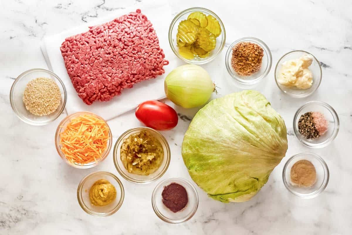 Ground beef, lettuce, tomato, pickles, onion, cheese, mayonnaise, mustard, and seasonings.